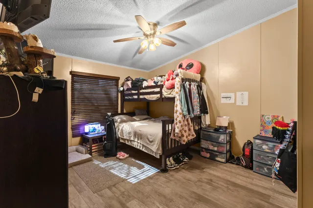 a bedroom with a bed and a tv