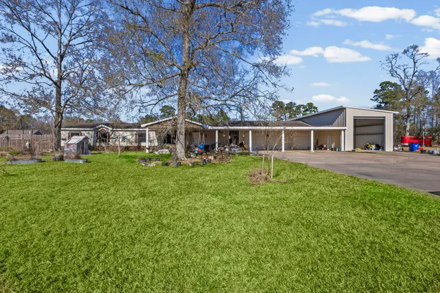 a view of a house with a backyard porch and sitting area