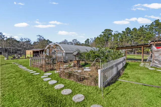 a backyard of a house with barbeque oven table and chairs