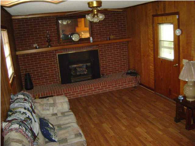 545 Richardson Road DeFuniak Springs, FL 32433 - Photo 11 of 22 a living room with furniture a fireplace and a flat screen tv