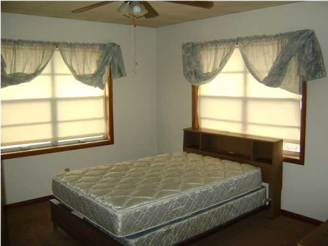 545 Richardson Road DeFuniak Springs, FL 32433 - Photo 13 of 22 a bed sitting in a bedroom next to a window