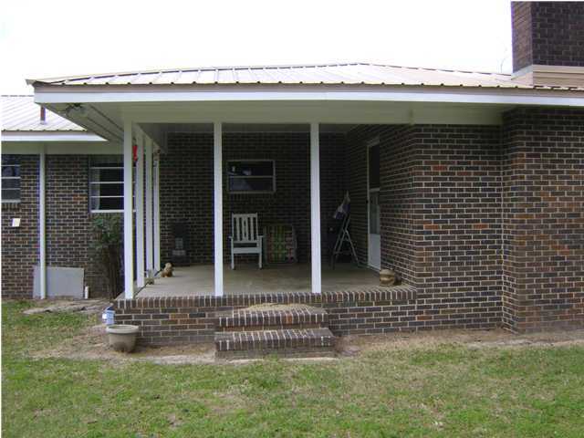 545 Richardson Road DeFuniak Springs, FL 32433 - Photo 6 of 22 a view of a house with a large window and a yard