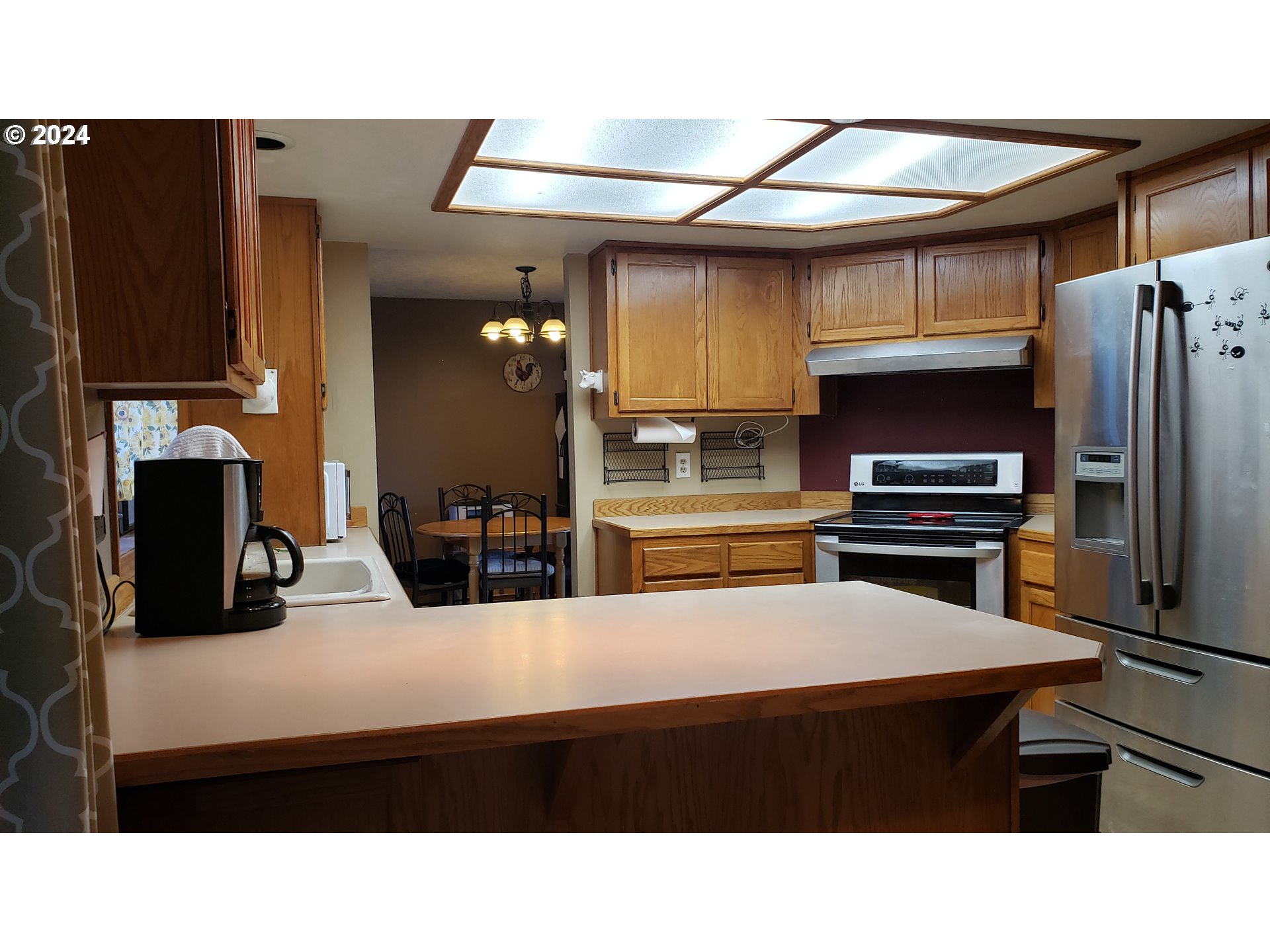 1442 Southwest Wallula Drive Gresham, OR 97080 - Photo 8 of 24 a kitchen with a refrigerator a stove and a sink