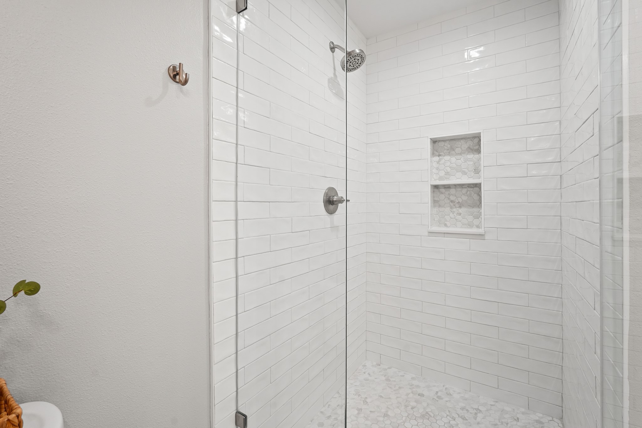 5242 Sanford Road Houston, TX 77035 - Photo 21 of 34 Newly remodeled walk-in shower with white subway tiles, a built-in niche, and a seamless shower door. Modern fixtures, lighting, and faucets make this a true gem!