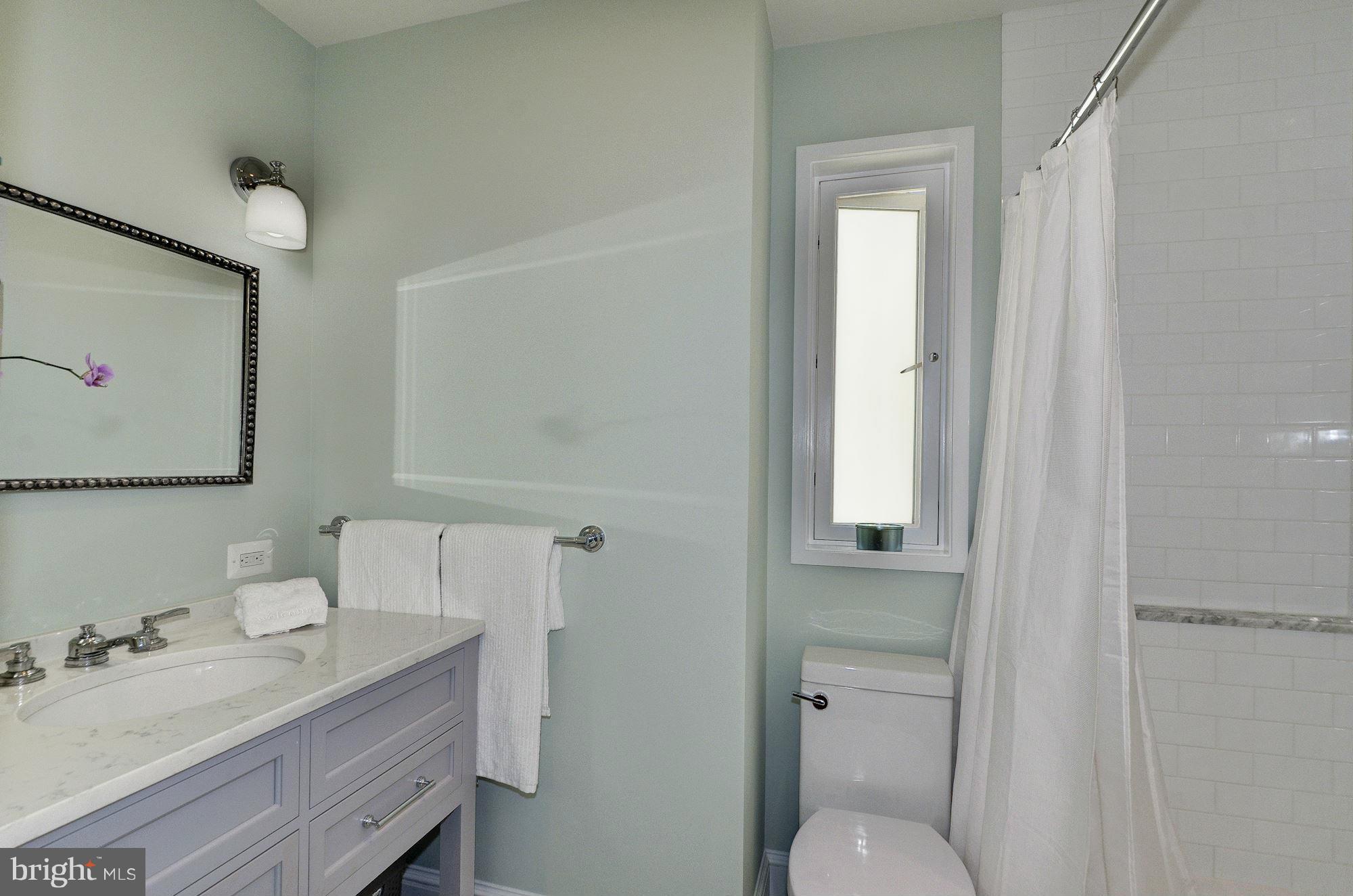 3316 Reservoir Road Northwest Washington, DC 20007 - Photo 11 of 19 a bathroom with a granite countertop sink toilet and mirror