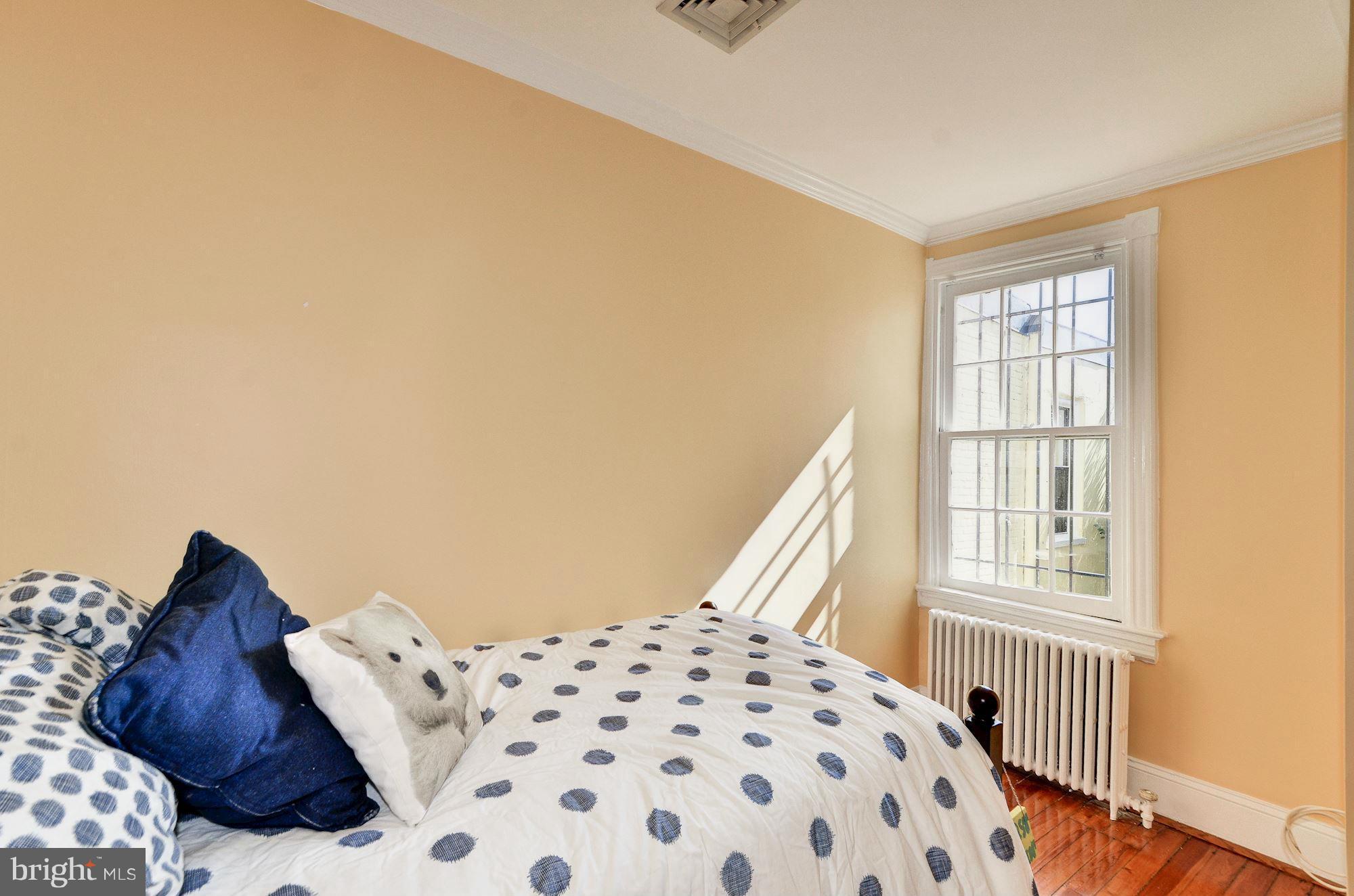 3316 Reservoir Road Northwest Washington, DC 20007 - Photo 13 of 19 a bedroom with a bed and a window