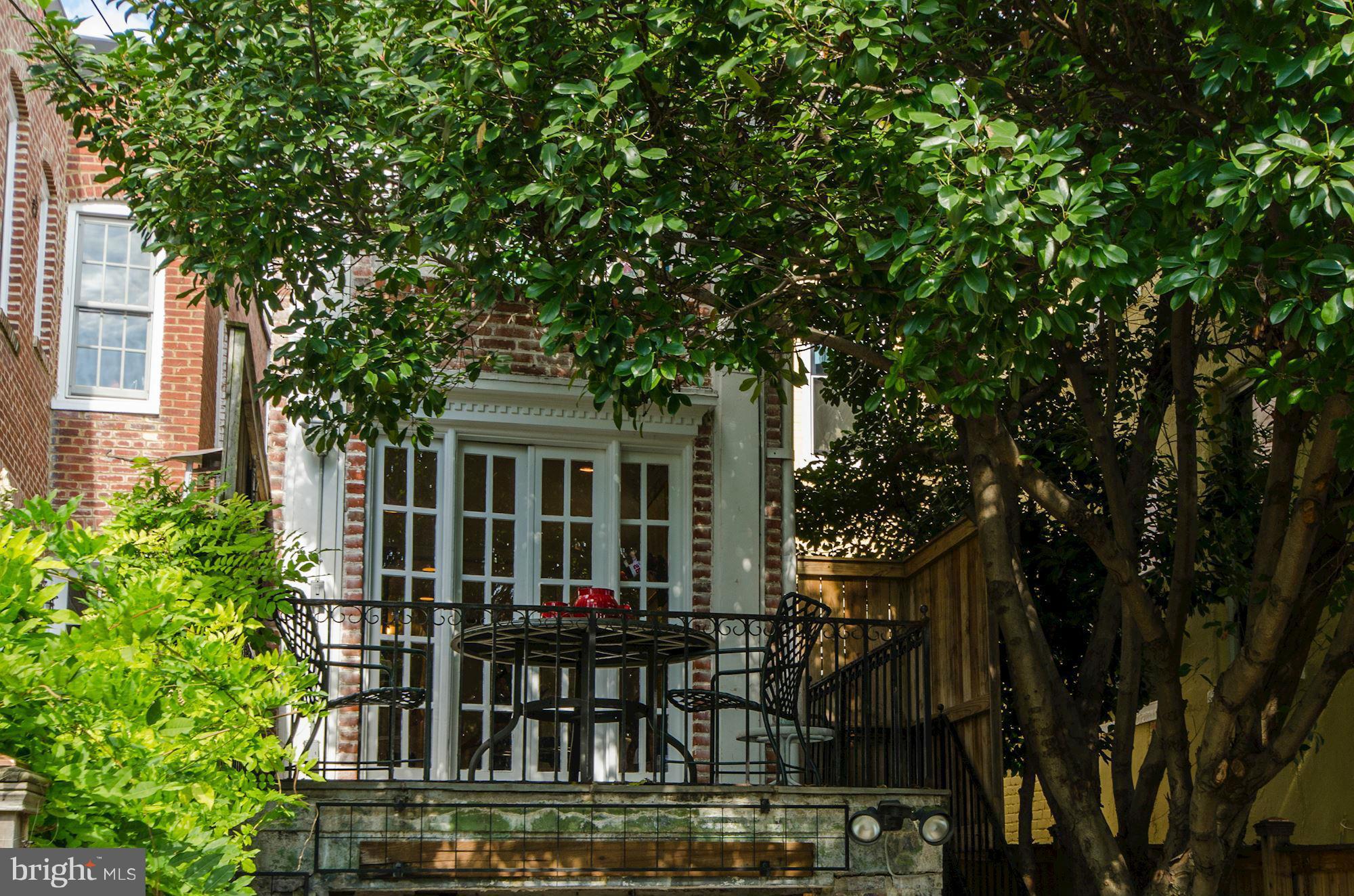 3316 Reservoir Road Northwest Washington, DC 20007 - Photo 19 of 19 a front view of house with yard and trees around