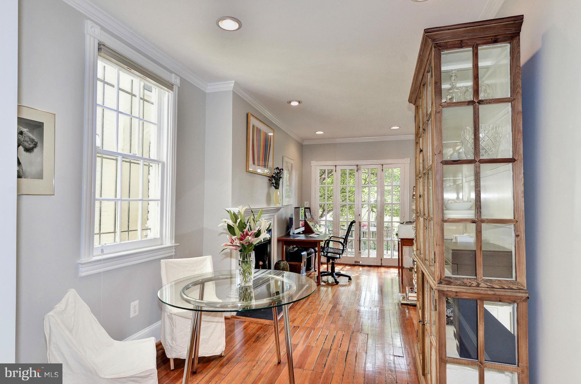 3316 Reservoir Road Northwest Washington, DC 20007 - Photo 4 of 19 a dining room with furniture a chandelier and wooden floor