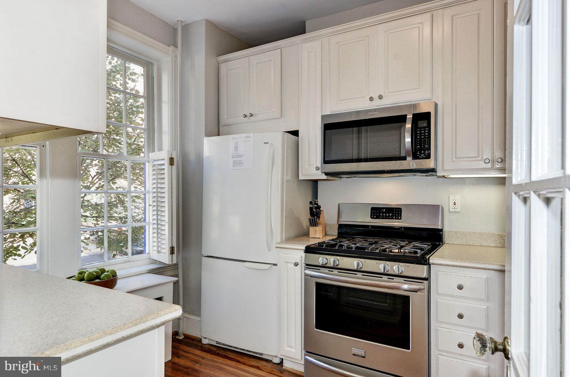 3316 Reservoir Road Northwest Washington, DC 20007 - Photo 6 of 19 a kitchen with granite countertop a refrigerator stove and microwave