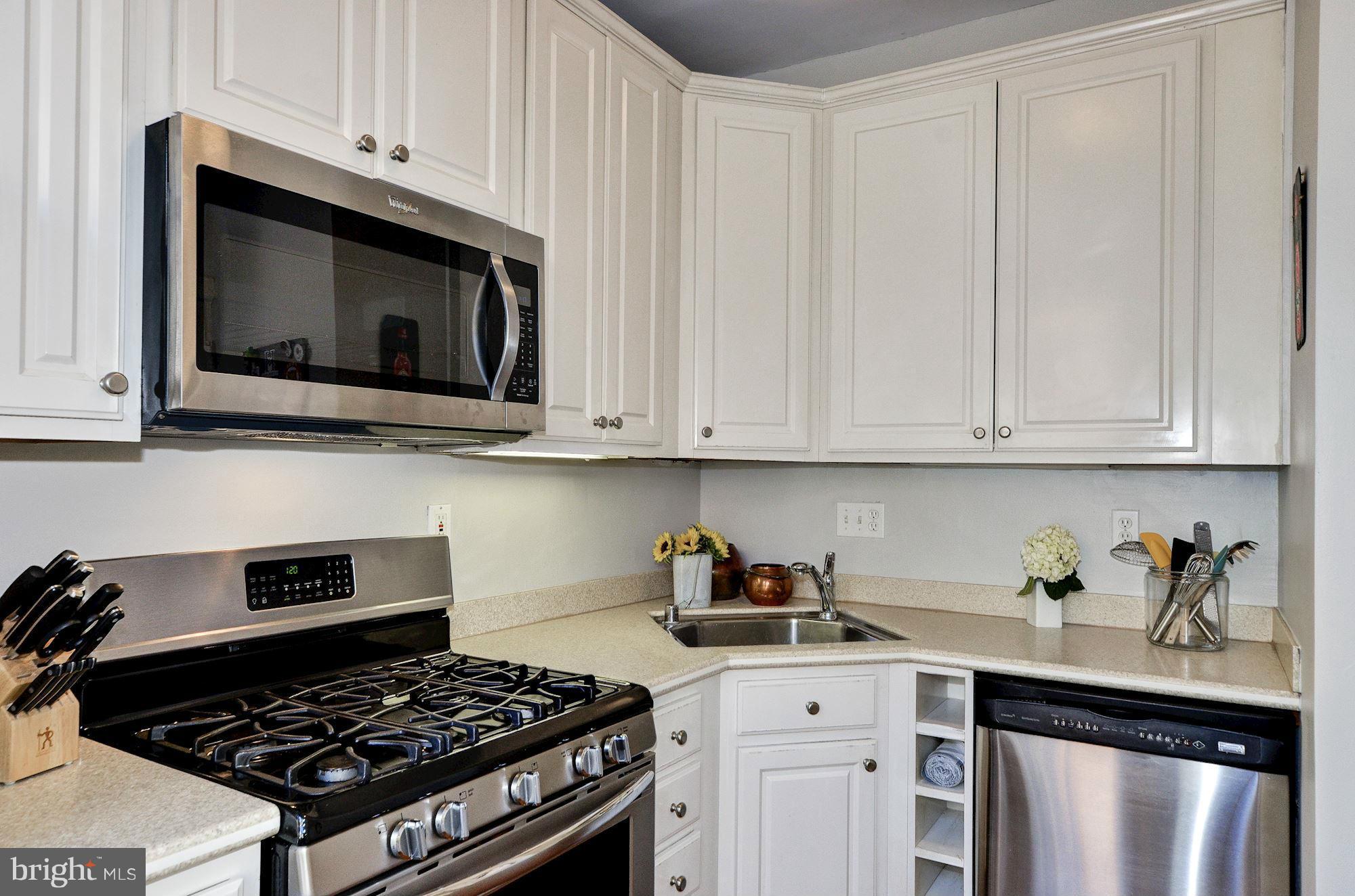 3316 Reservoir Road Northwest Washington, DC 20007 - Photo 7 of 19 a kitchen with stainless steel appliances granite countertop white cabinets a stove a sink and dishwasher