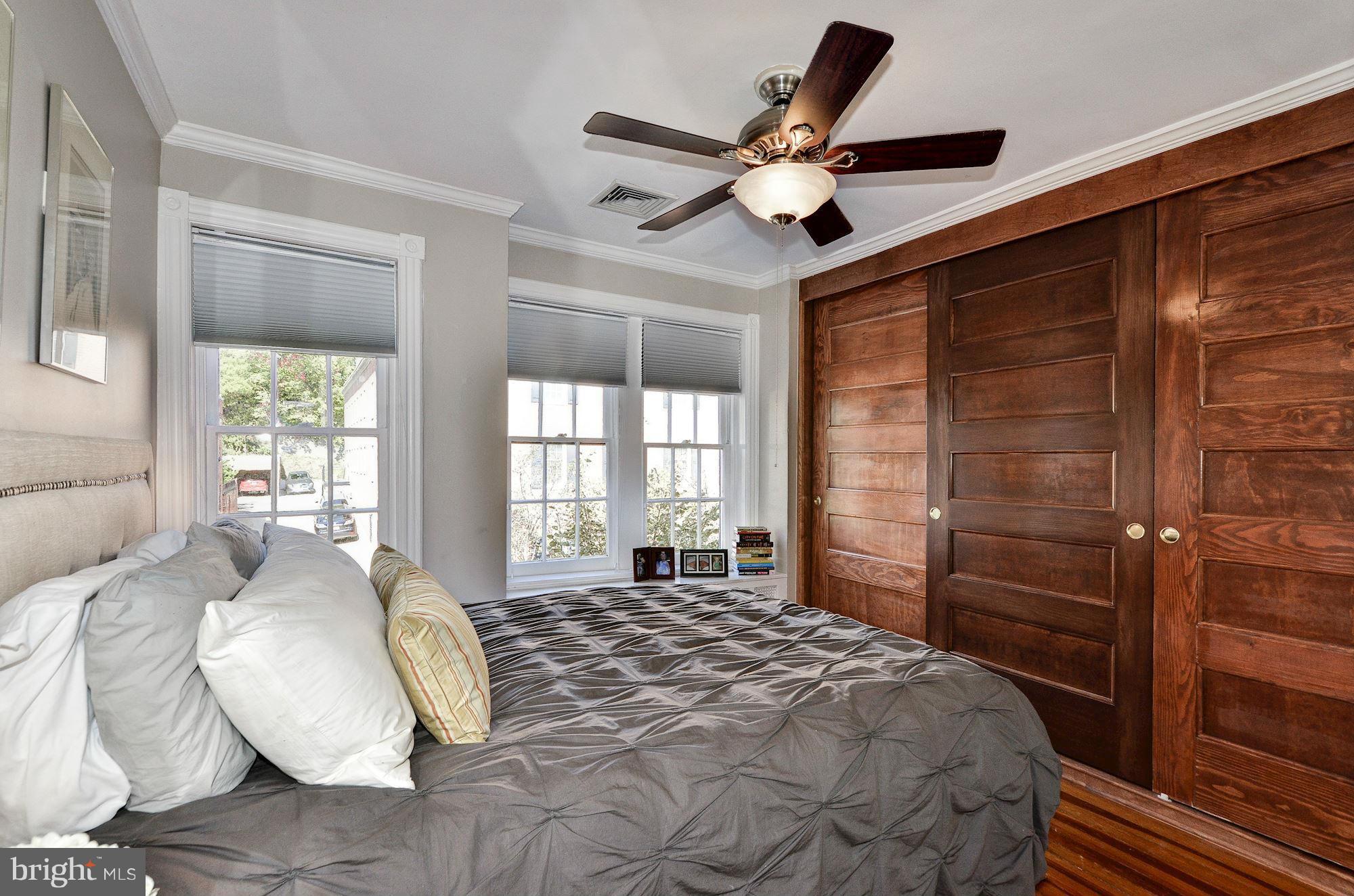3316 Reservoir Road Northwest Washington, DC 20007 - Photo 9 of 19 a bedroom with a large bed and a chandelier