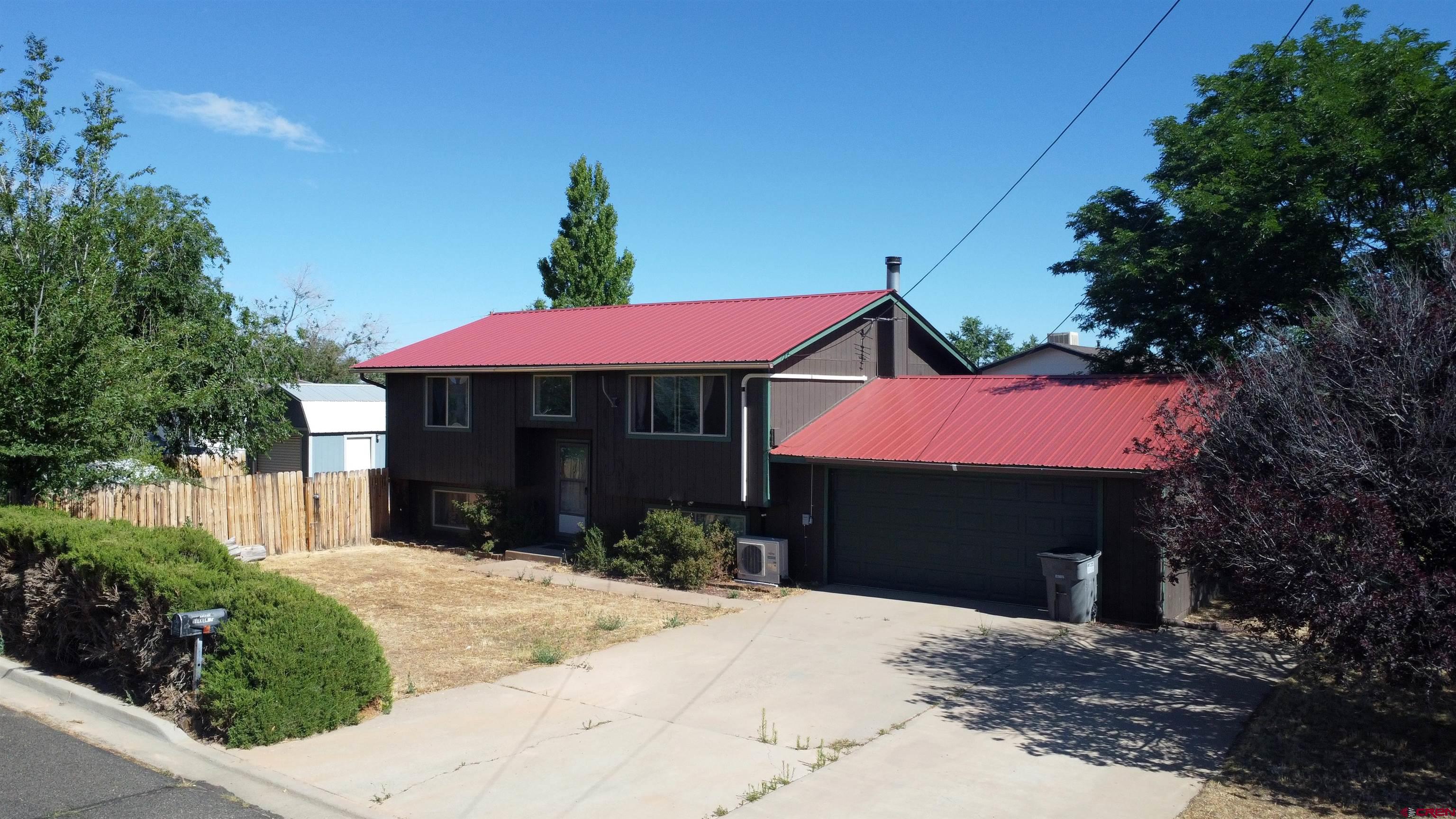 1328 Jackson Street Cortez, CO 81321 - Photo 1 of 37 a front view of a house with yard and trees