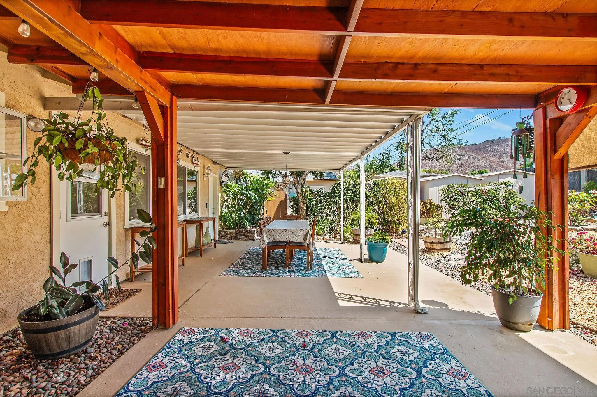 1701 Pepper Villa Drive El Cajon, CA 92021 - Photo 19 of 23 a view of a patio with table and chairs potted plants and floor to ceiling window and potted plants