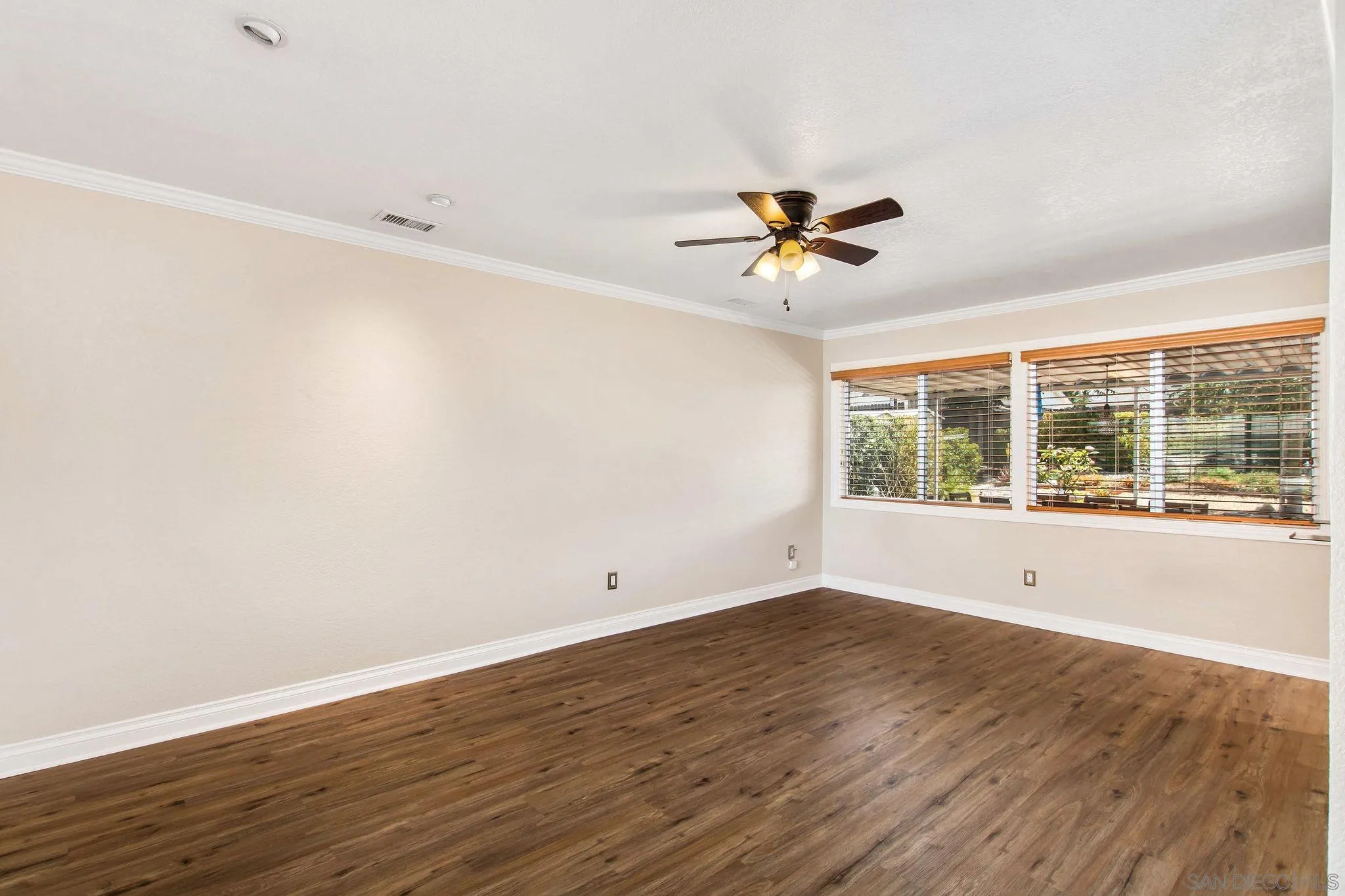 1701 Pepper Villa Drive El Cajon, CA 92021 - Photo 3 of 23 a view of an empty room with a window and wooden floor
