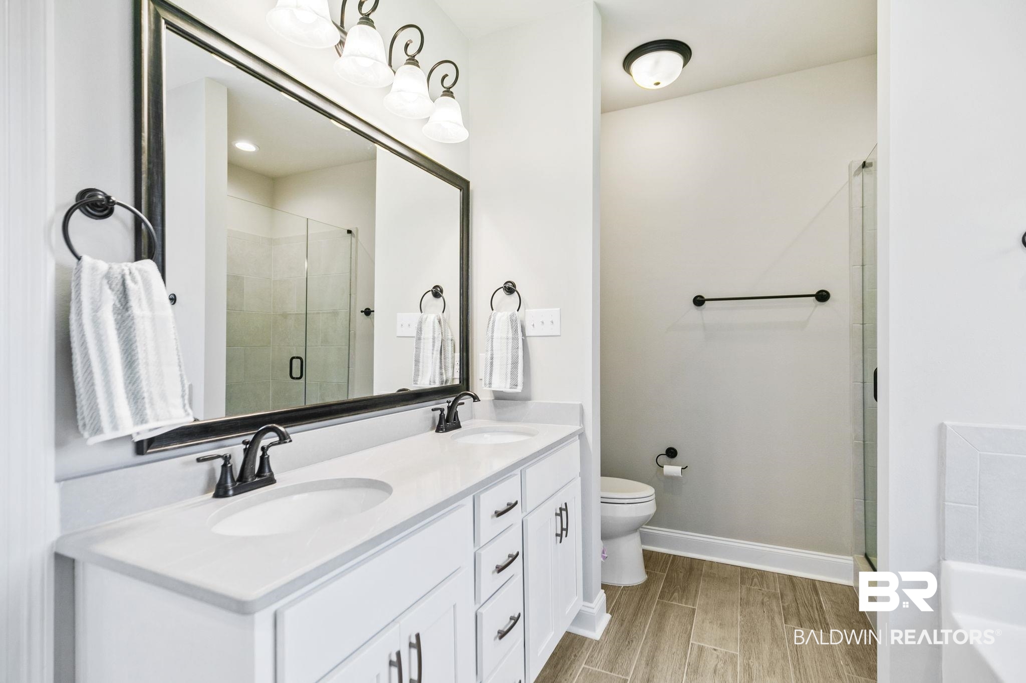 10140 Chipper Lane Foley, AL 36535 - Photo 29 of 72 Bathroom with a shower with shower door, toilet, and vanity