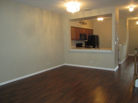 17794 Braewick Road Gurnee, IL 60031 - Photo 5 of 18 an empty room with wooden floor and a bathroom