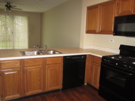17794 Braewick Road Gurnee, IL 60031 - Photo 6 of 18 a kitchen with granite countertop a sink and a stove top oven