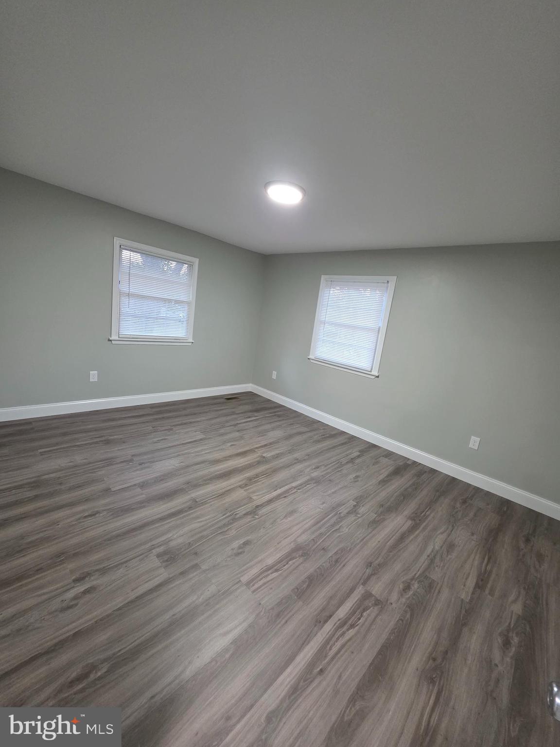 3604 Lakota Road Alexandria, VA 22303 - Photo 11 of 25 an empty room with wooden floor and windows