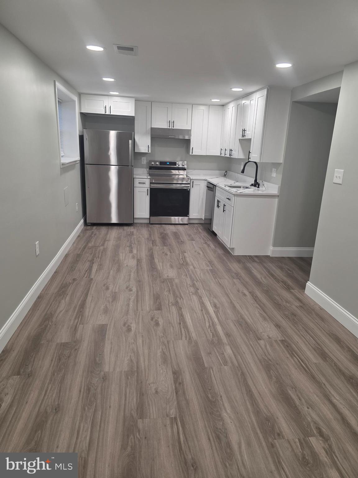 3604 Lakota Road Alexandria, VA 22303 - Photo 14 of 25 a kitchen with a refrigerator a sink and a stove top oven