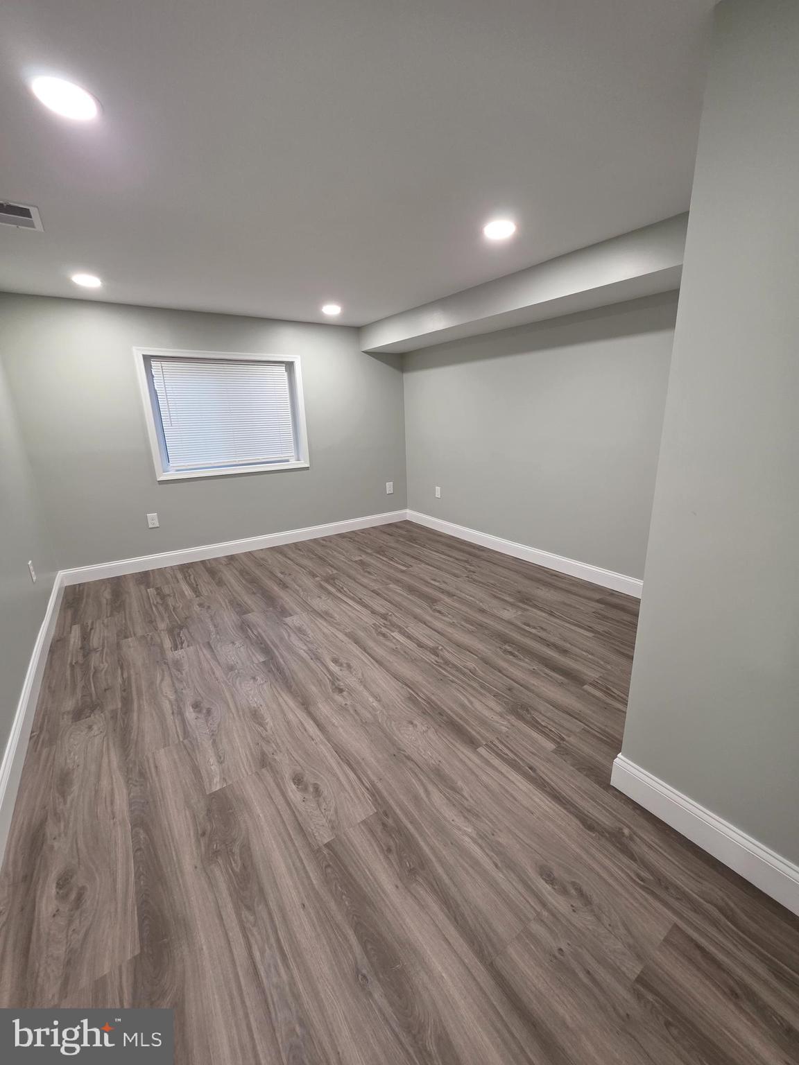 3604 Lakota Road Alexandria, VA 22303 - Photo 21 of 25 an empty room with wooden floor and windows