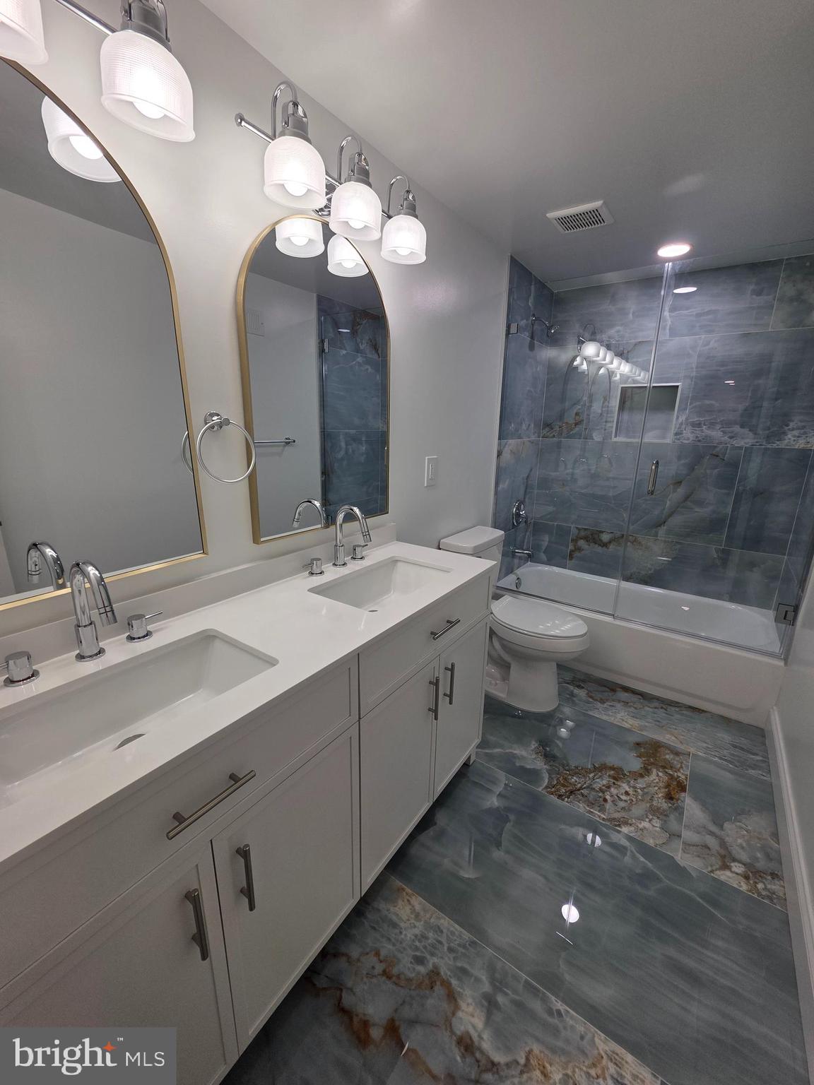 3604 Lakota Road Alexandria, VA 22303 - Photo 22 of 25 a bathroom with a double vanity sink mirror and toilet