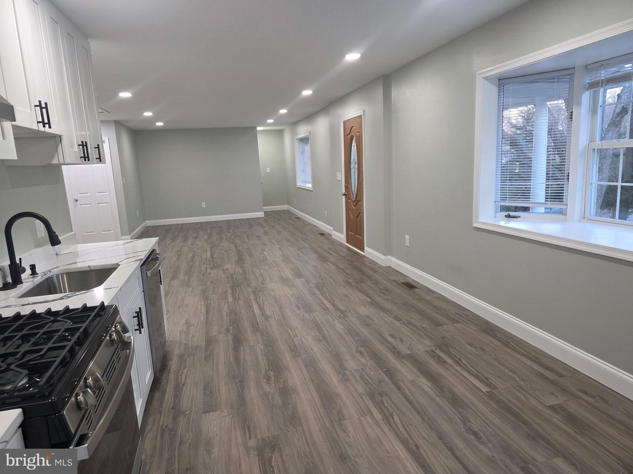 3604 Lakota Road Alexandria, VA 22303 - Photo 5 of 25 a view of a kitchen with a sink wooden floor and windows