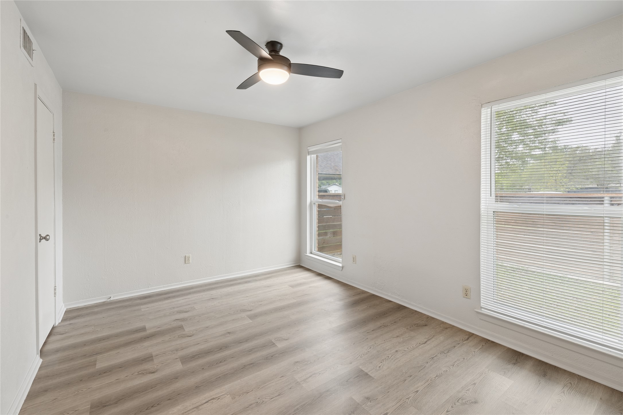 820 Sahara Avenue, Unit B Austin, TX 78745 - Photo 25 of 29 Unfurnished bedroom with ceiling fan, light wood finished floors, and a closet