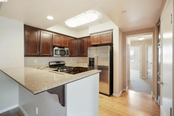 a kitchen with a refrigerator a stove a sink and a refrigerator