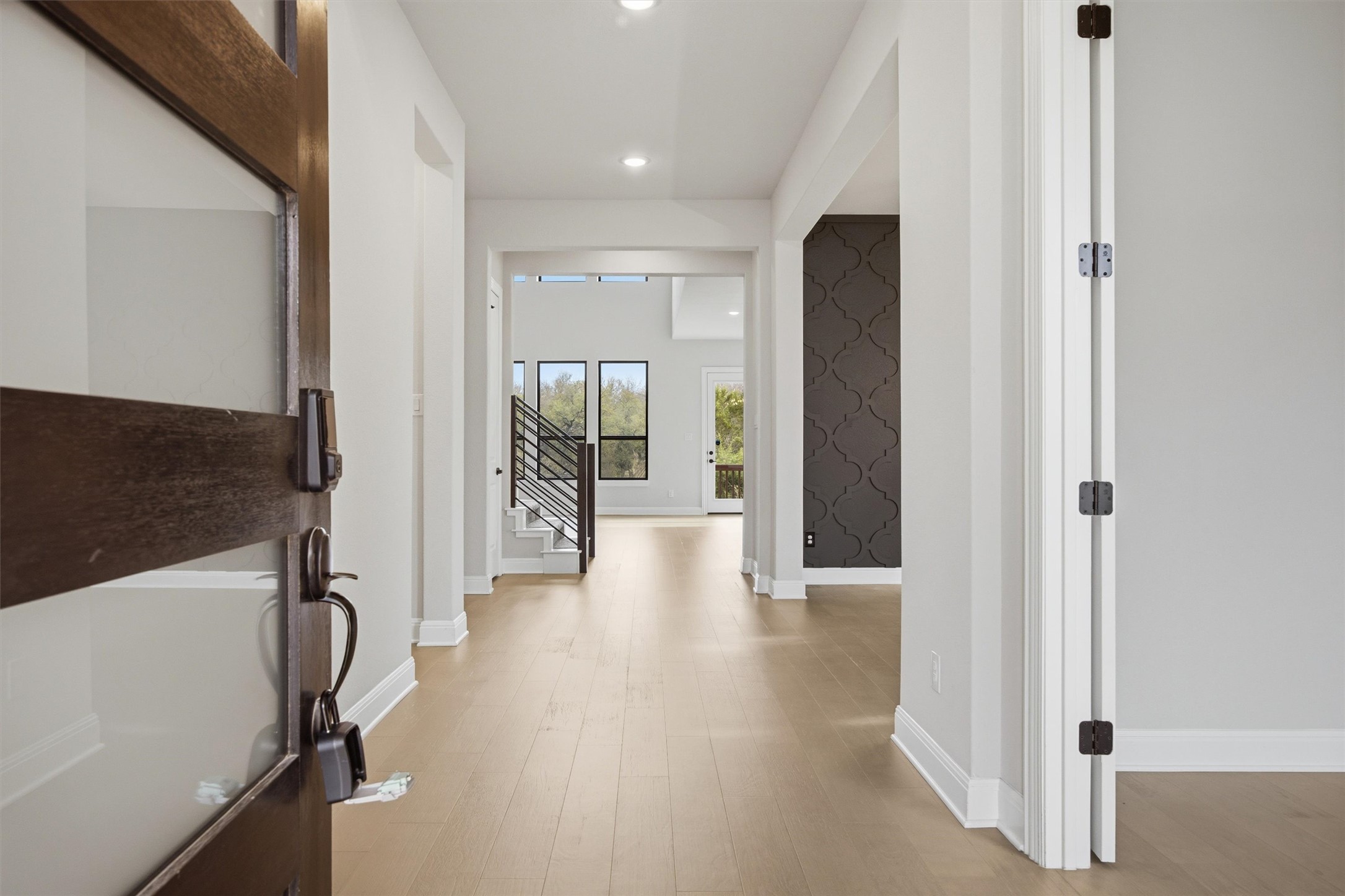 208 Tovas Secret Cove Georgetown, TX 78628 - Photo 4 of 40 a view of a hallway with wooden floor and glass door