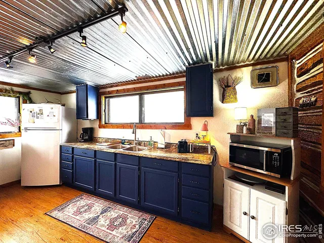 a bed sitting in a spacious bedroom next to a window