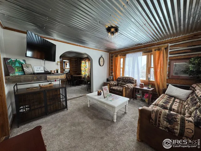a living room with furniture and large windows