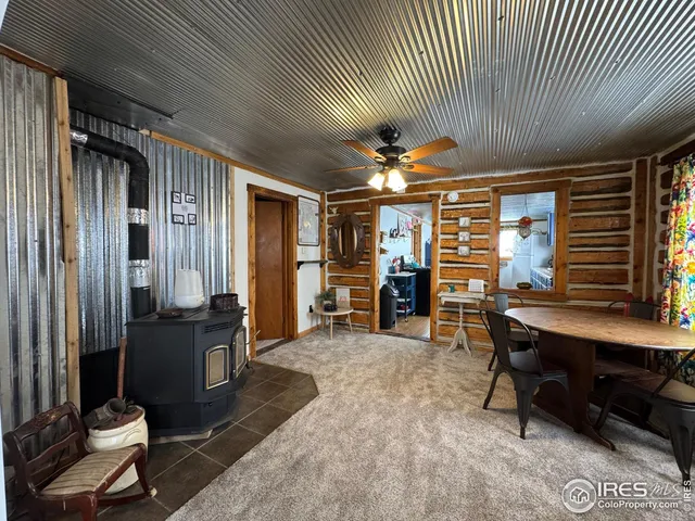 a living room with furniture a desk and chair with a bookshelf