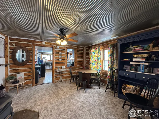 a dining room with furniture and a potted plant