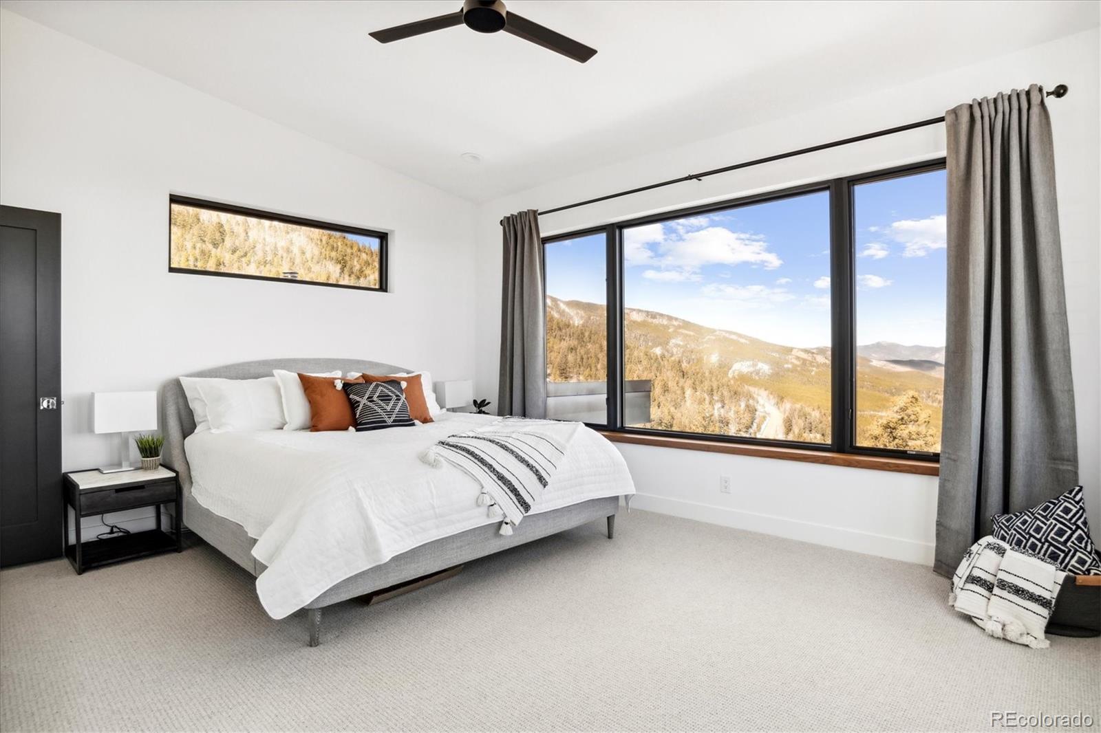 10199 Christopher Drive Conifer, CO 80433 - Photo 14 of 40 a large bed sitting in a bedroom next to a window