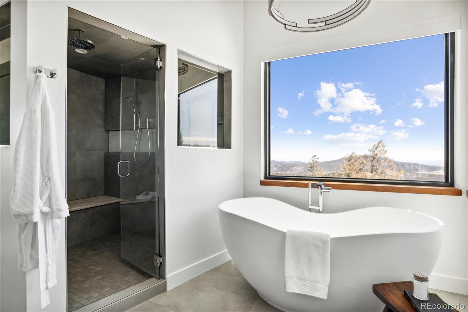 10199 Christopher Drive Conifer, CO 80433 - Photo 17 of 40 a bathroom with a bathtub and shower