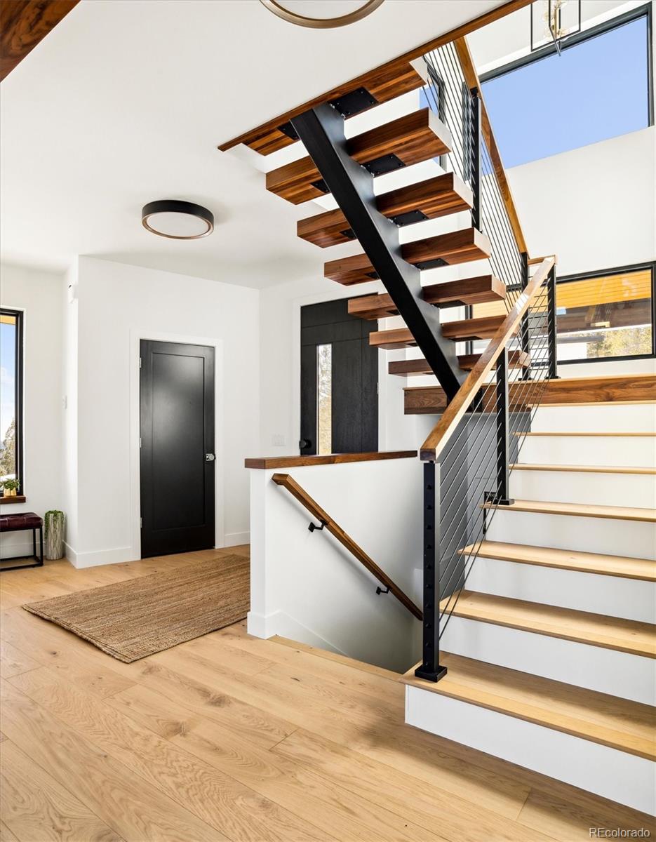 10199 Christopher Drive Conifer, CO 80433 - Photo 3 of 40 a view of entryway and hall with wooden floor