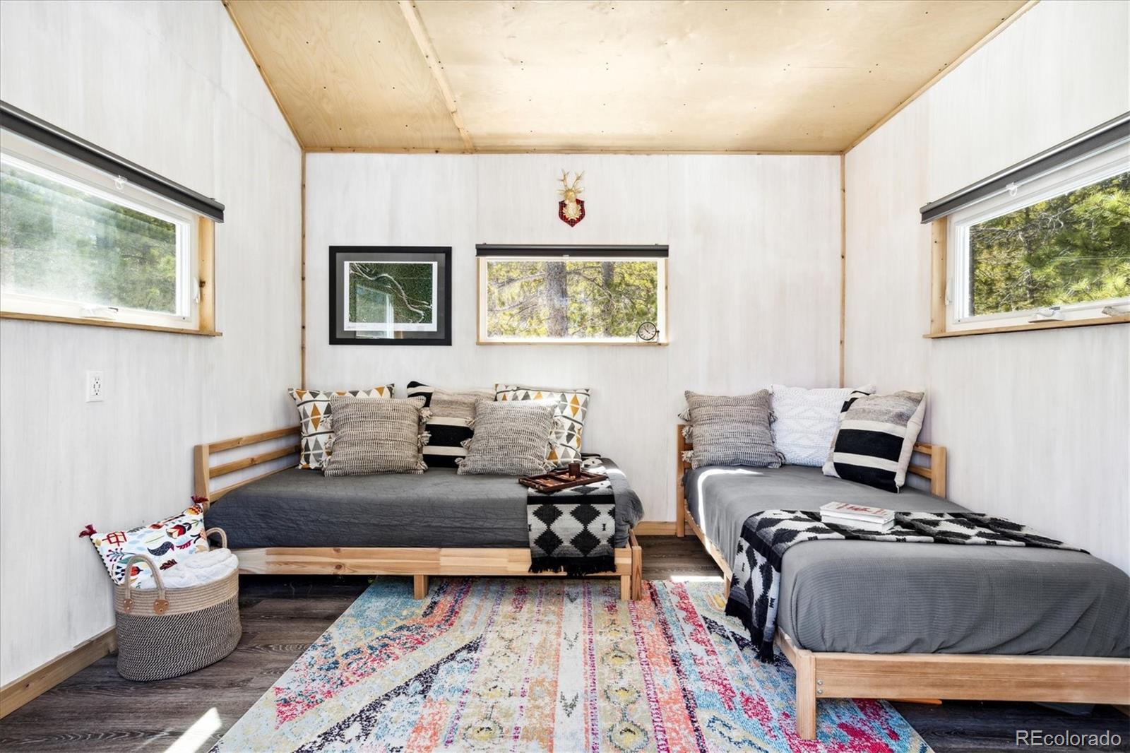 10199 Christopher Drive Conifer, CO 80433 - Photo 35 of 40 a bedroom with furniture and a mirror