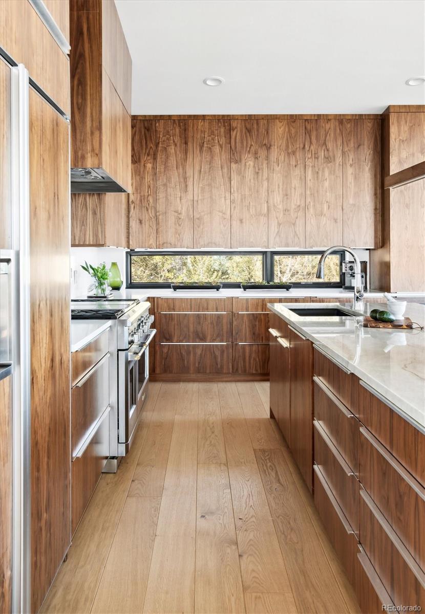10199 Christopher Drive Conifer, CO 80433 - Photo 6 of 40 a kitchen with stainless steel appliances a sink and cabinets