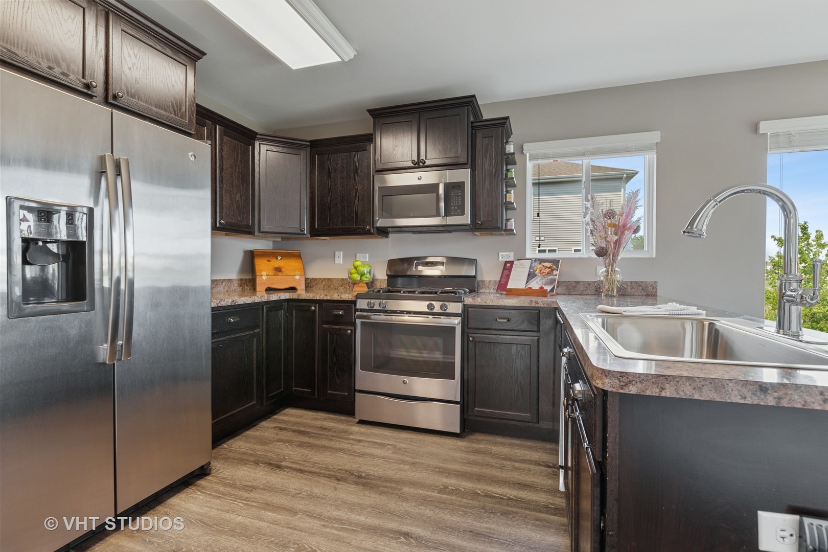 1141 Piccolo Lane Volo, IL 60073 - Photo 6 of 29 a kitchen with stainless steel appliances granite countertop a refrigerator sink and stove