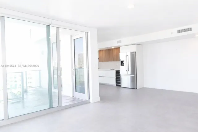 a view of a kitchen with a refrigerator and a sink