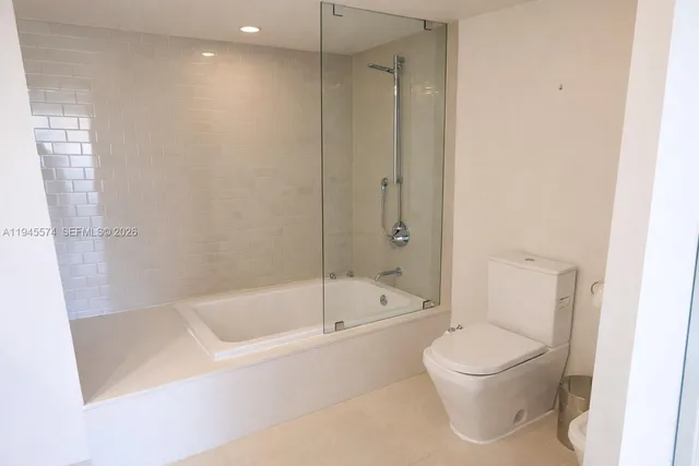 a bathroom with a bathtub and a toilet