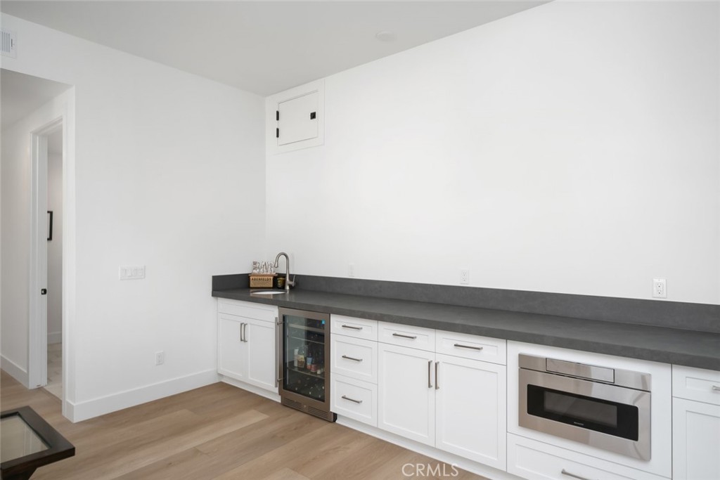 4019 Hillside Drive San Luis Obispo, CA 93401 - Photo 20 of 32 a kitchen with granite countertop white cabinets and white appliances