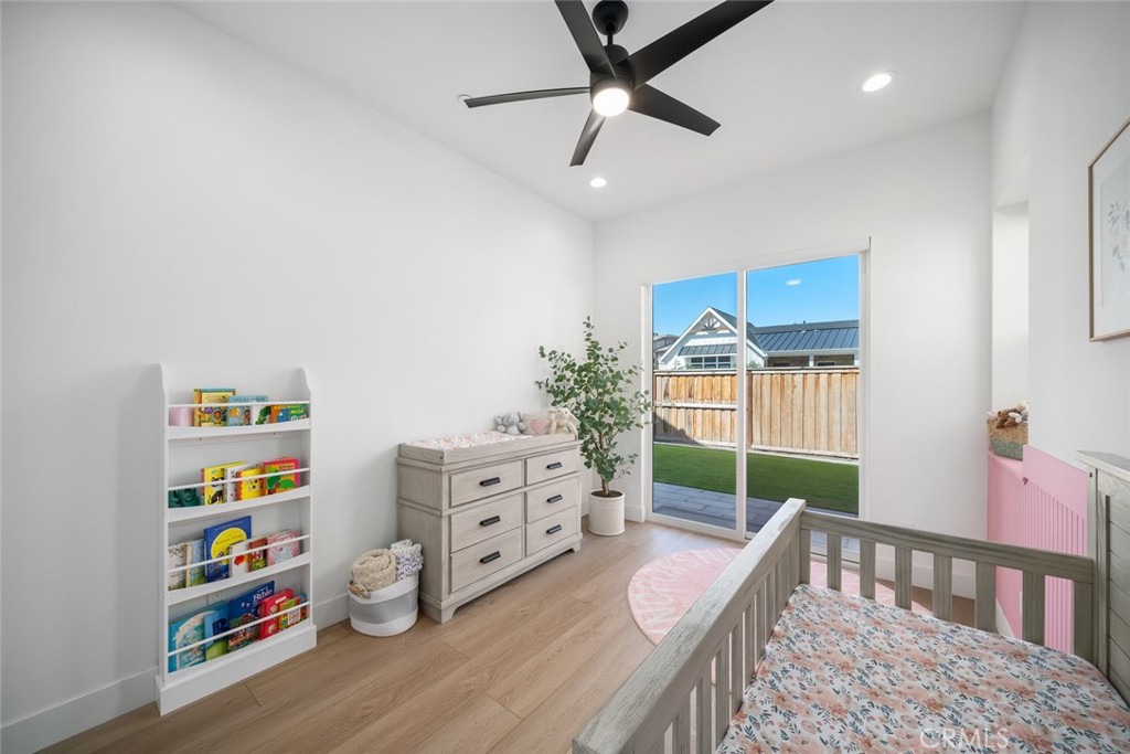 4019 Hillside Drive San Luis Obispo, CA 93401 - Photo 24 of 32 a bedroom with furniture a baby crib and a wooden floor