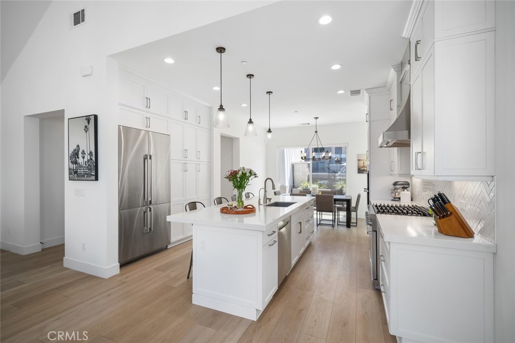 4019 Hillside Drive San Luis Obispo, CA 93401 - Photo 9 of 32 a living room with stainless steel appliances kitchen island granite countertop furniture wooden floor and a view of kitchen