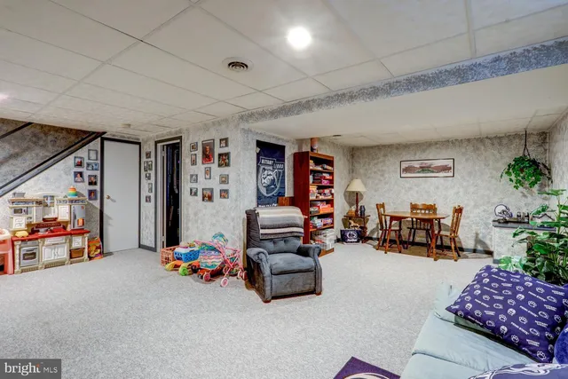 a living room with furniture and a book shelf