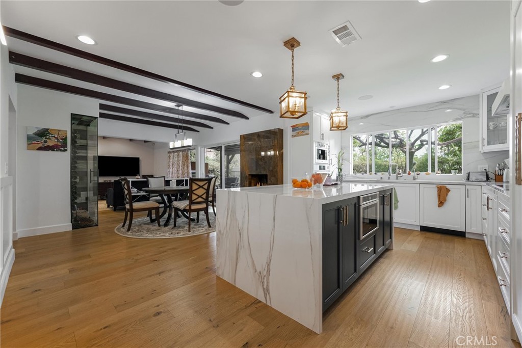 a kitchen with stainless steel appliances kitchen island a large island in the center