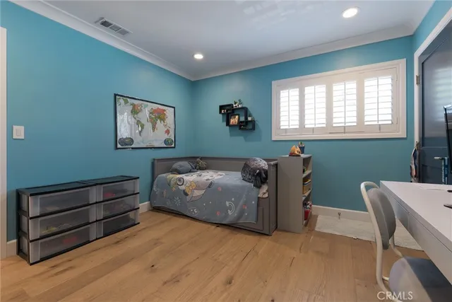 a bedroom with furniture and a flat screen tv