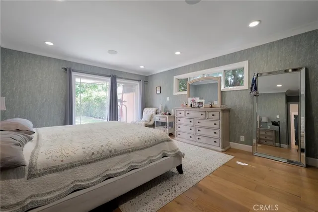 a spacious bedroom with a bed and furniture