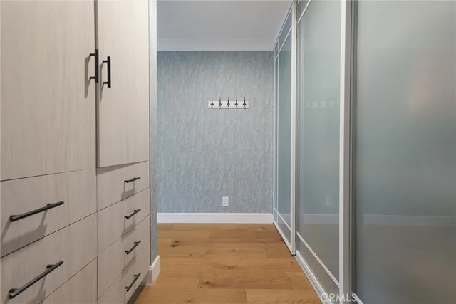 a bathroom with a glass shower door and mirror