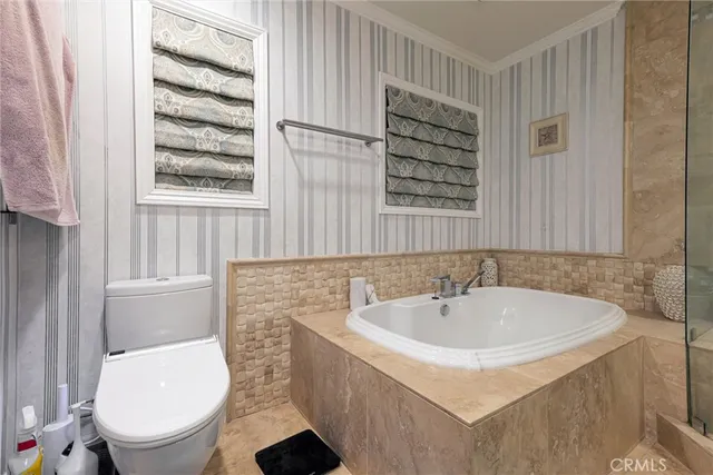 a bathroom with a tub sink double and mirror